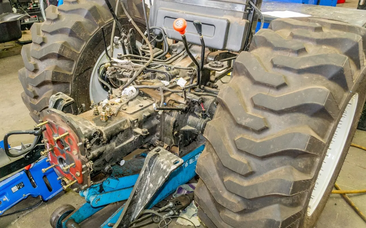 Tractor split open for transmission work in a workshop