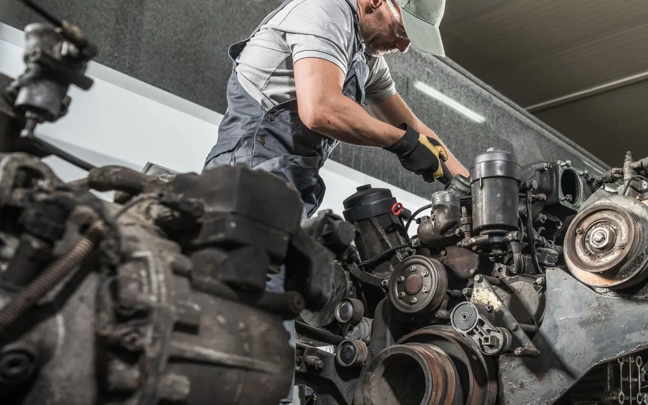 Technician working on a heavy diesel engine