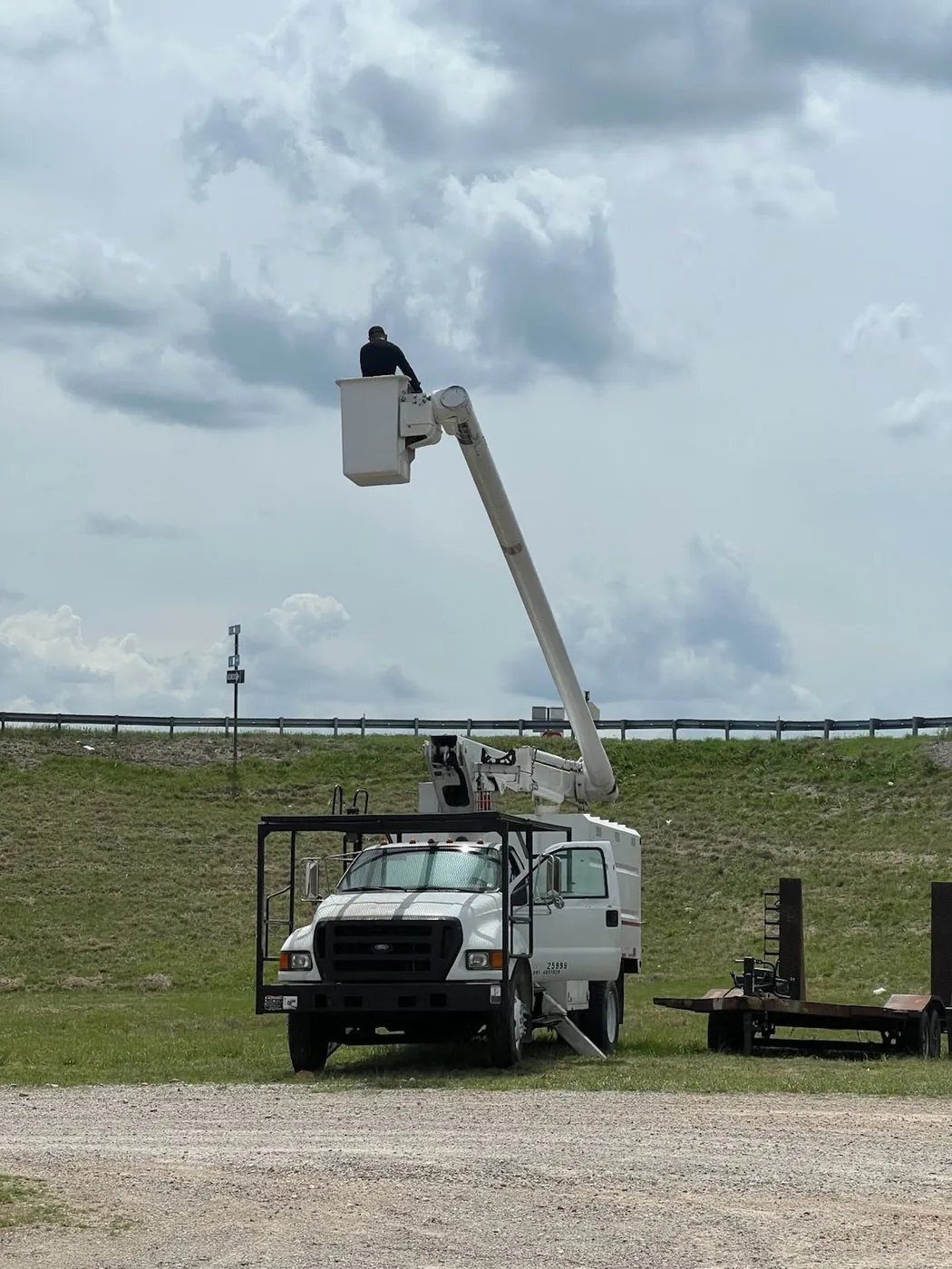 Bucket truck receiving field service from a mobile mechanic