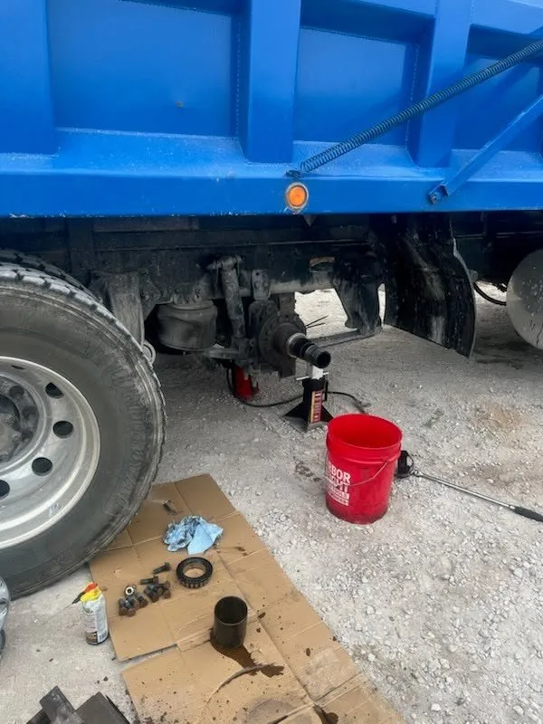 Dump truck wheel hub repair being carried out