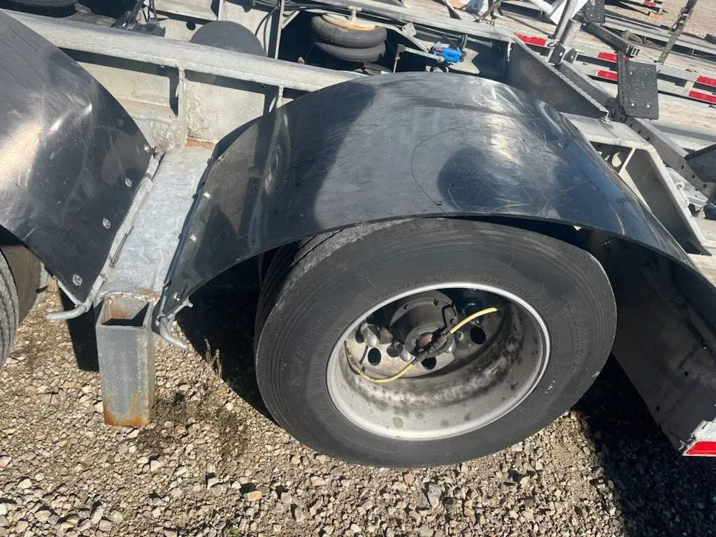 Trailer wheel and fender undergoing repair