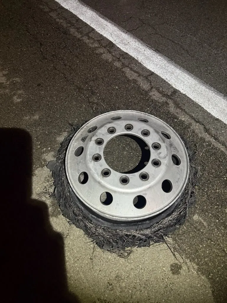 Truck wheel and rim being repaired at the roadside