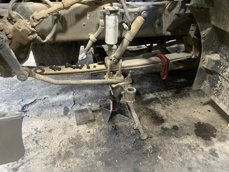 Truck axle and suspension components being repaired