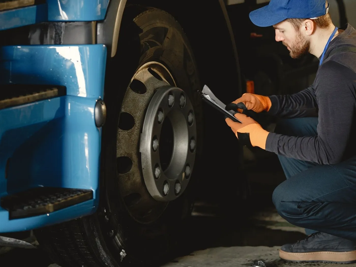 Inspector checking a commercial truck wheel and brake assembly
