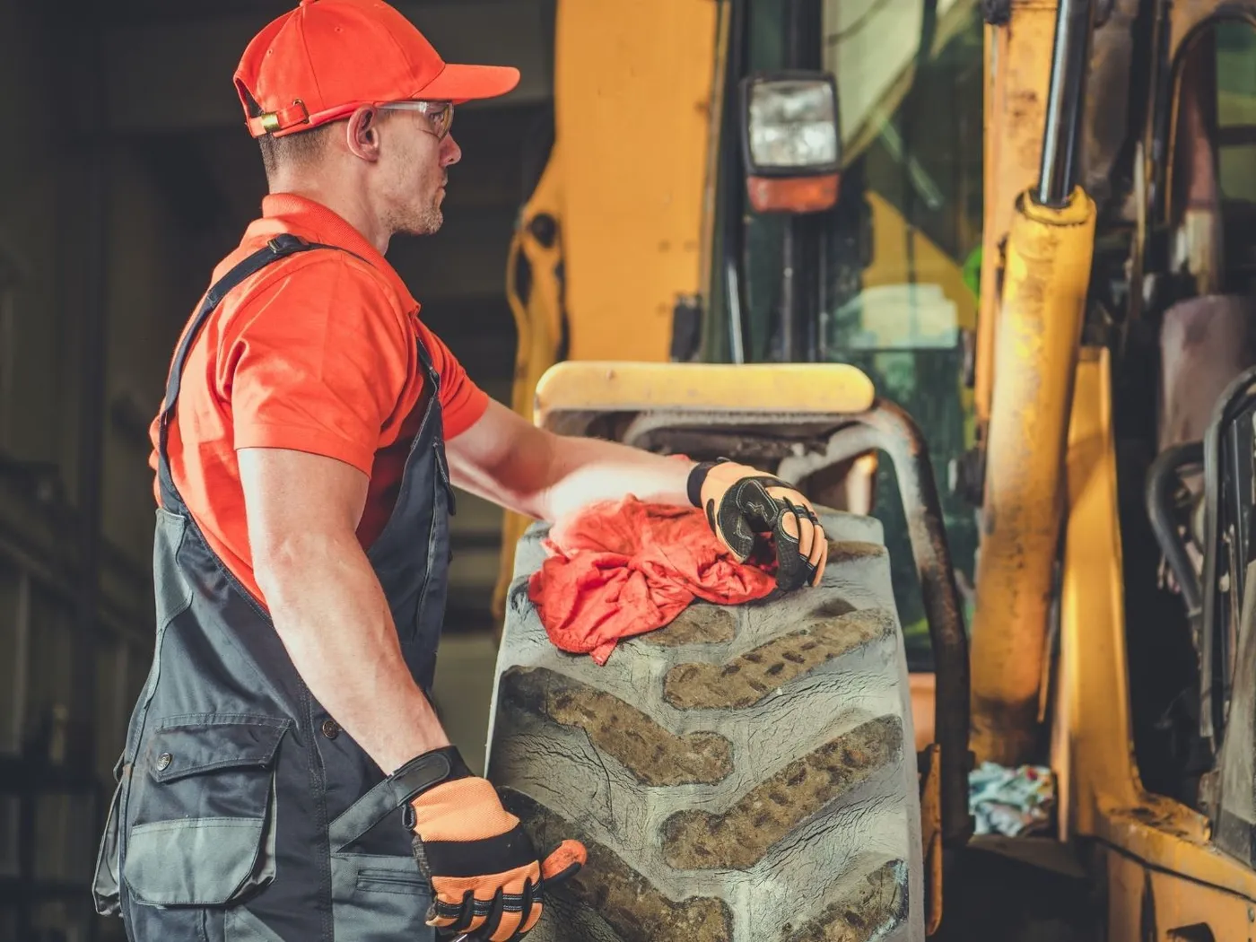 Mechanic servicing heavy construction equipment